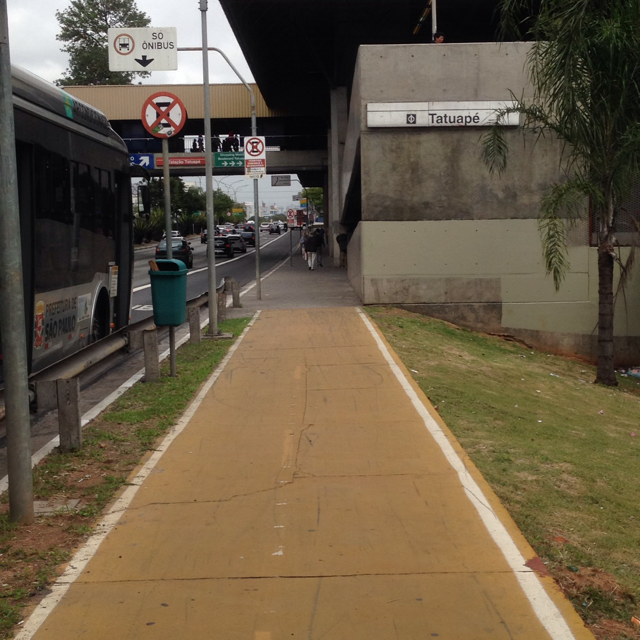 Sidewalk with bus on the left